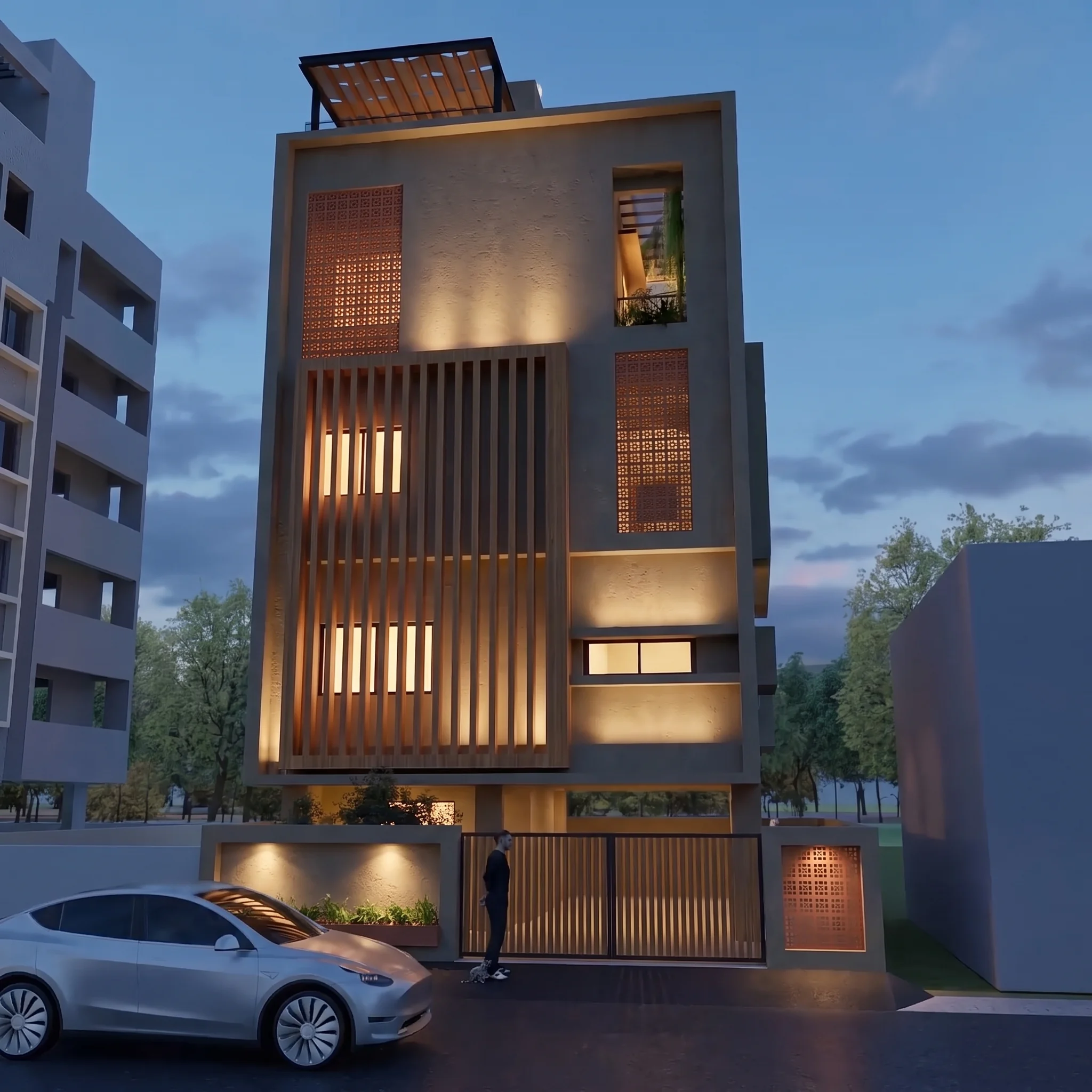 The same house at dusk, lit from behind its teak screen